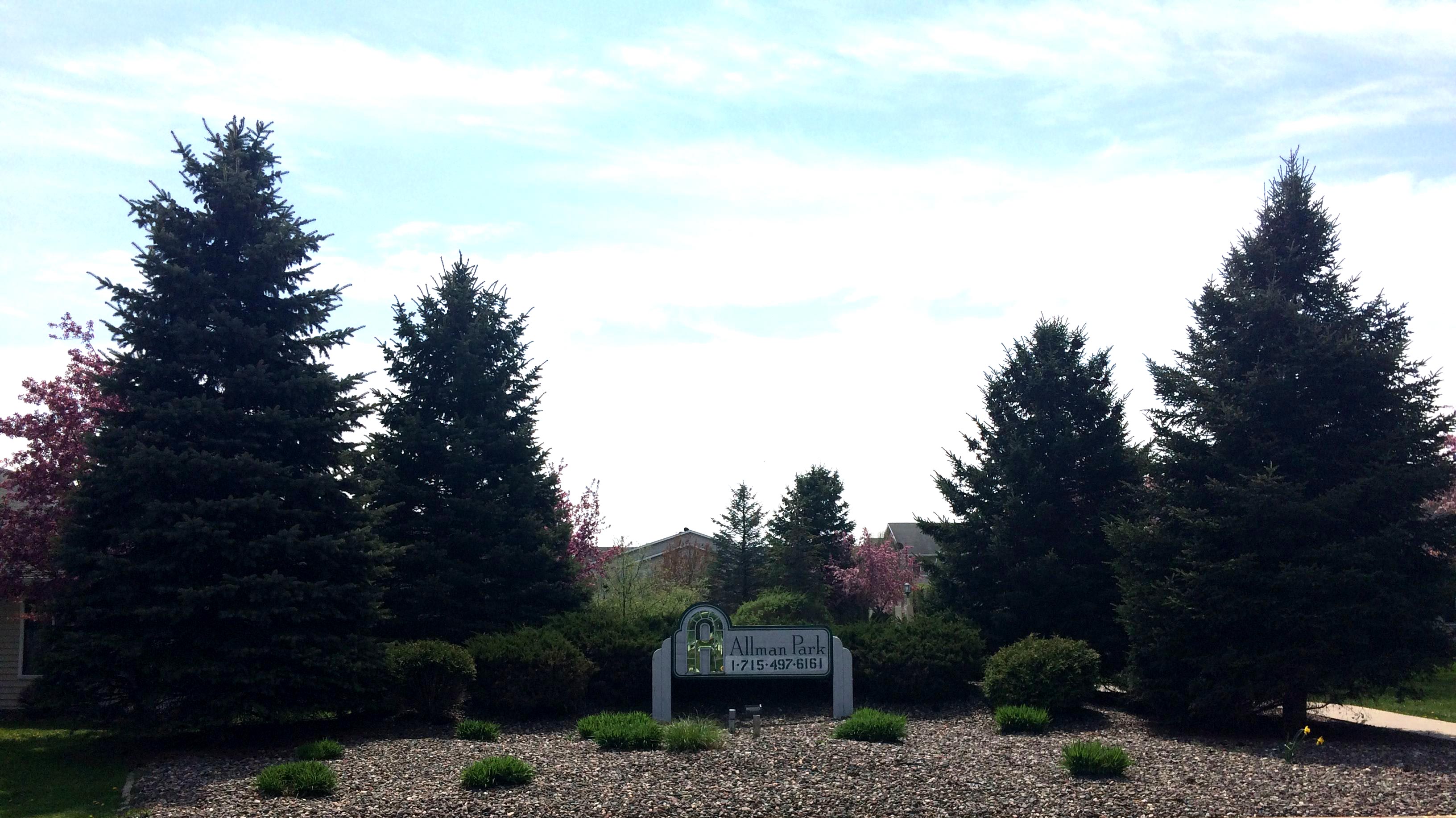 allman-park-sign-place-in-rock-garden-surrounded-by-trees