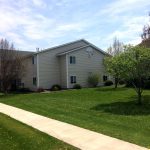 side-view-of-apartment-building-green-grass