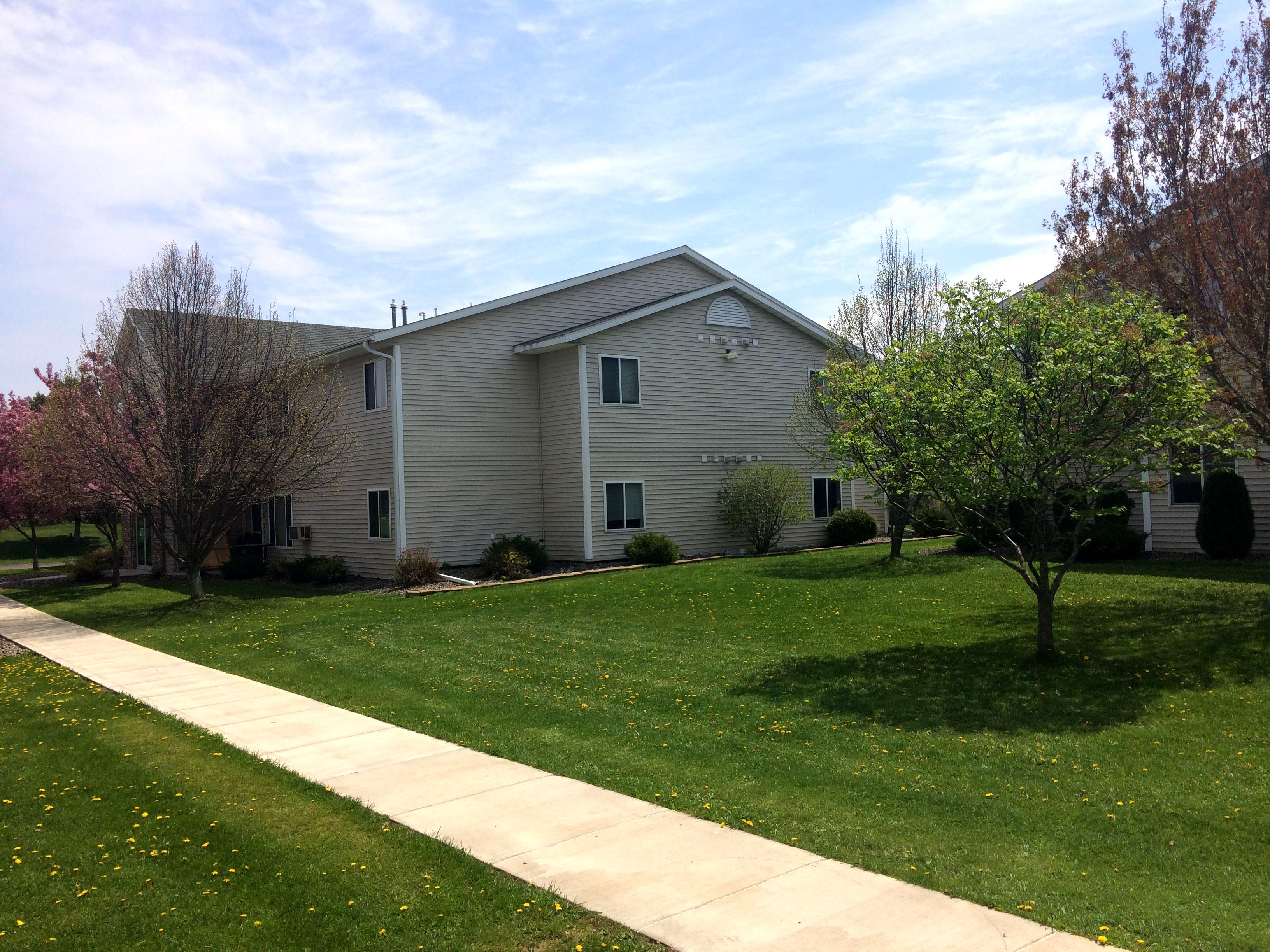 side-view-of-apartment-building-green-grass